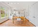 Eat-in kitchen featuring a center island, stainless steel appliances, white cabinets, and hardwood floors at 1128 Bellewood Sq, Dunwoody, GA 30338