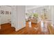 Open-concept living area boasting hardwood floors, white walls, and access to outdoor views at 1128 Bellewood Sq, Dunwoody, GA 30338