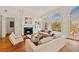 Bright living room with a fireplace, hardwood floors, and large arched windows bringing in natural light at 1128 Bellewood Sq, Dunwoody, GA 30338