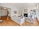 Open-concept living room with hardwood floors, fireplace, and large windows creating a bright and airy space at 1128 Bellewood Sq, Dunwoody, GA 30338