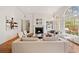 Inviting living room featuring a fireplace, hardwood floors, and large windows that offer natural light at 1128 Bellewood Sq, Dunwoody, GA 30338