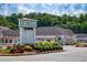 A suburban shopping center with a variety of shops, mature trees, and lush landscaping at 1128 Bellewood Sq, Dunwoody, GA 30338