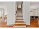 Elegant staircase with hardwood steps and white risers, connecting the home's levels at 1128 Bellewood Sq, Dunwoody, GA 30338