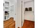 Spacious walk-in closet featuring custom shelving and hardwood floors, providing ample storage at 1128 Bellewood Sq, Dunwoody, GA 30338