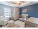 Cozy Bedroom room with an accent wall, a crib, and a comfortable armchair at 1382 Doublegate Ne Dr, Atlanta, GA 30319