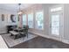 Cozy dining area with modern lighting, table with bench seating, and an exterior door at 1382 Doublegate Ne Dr, Atlanta, GA 30319