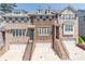 Attractive brick townhome featuring multi-car garage and brick staircase leading to the front entrance at 1382 Doublegate Ne Dr, Atlanta, GA 30319