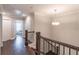 Upstairs hallway with hardwood floors, stylish railing, and recessed lighting at 1382 Doublegate Ne Dr, Atlanta, GA 30319