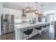 Bright open kitchen featuring a stainless steel refrigerator, white cabinets, large island, and bar stool seating at 1382 Doublegate Ne Dr, Atlanta, GA 30319