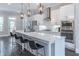 Bright kitchen featuring a stainless steel appliance suite, modern white cabinets, and an island with bar stool seating at 1382 Doublegate Ne Dr, Atlanta, GA 30319
