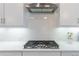 Close up of a gas stove with stainless steel hood at 1382 Doublegate Ne Dr, Atlanta, GA 30319