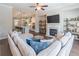Open concept living room view featuring a cozy sectional sofa, fireplace, and adjoining kitchen at 1382 Doublegate Ne Dr, Atlanta, GA 30319