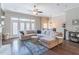 Spacious living room featuring hardwood floors, large sectional sofa, and a ceiling fan at 1382 Doublegate Ne Dr, Atlanta, GA 30319