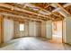 Unfinished basement featuring exposed beams, concrete floor, a door, and a blank canvas for customization at 1533 Fallen Leaf Sw Dr, Marietta, GA 30064