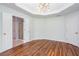 Spacious bedroom featuring hardwood floors, a trey ceiling, and multiple windows at 1533 Fallen Leaf Sw Dr, Marietta, GA 30064