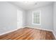 Neutral bedroom features wood floors, gray walls, and a window for natural light at 1533 Fallen Leaf Sw Dr, Marietta, GA 30064