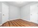 Bedroom features wood floors, gray walls, and two white doors at 1533 Fallen Leaf Sw Dr, Marietta, GA 30064