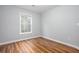 Small bedroom with wood floors, gray walls, and a window for natural light at 1533 Fallen Leaf Sw Dr, Marietta, GA 30064