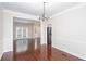 Open-concept dining room featuring hardwood floors, modern lighting and views into the kitchen at 1533 Fallen Leaf Sw Dr, Marietta, GA 30064