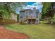 Back of house featuring a wooden deck overlooking a green backyard and mature trees at 1533 Fallen Leaf Sw Dr, Marietta, GA 30064