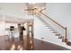 Open foyer boasts hardwood floors, staircase, and views of the kitchen island with granite counters at 1533 Fallen Leaf Sw Dr, Marietta, GA 30064