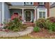 Inviting front porch surrounded by lush landscaping, brick entryway, and charming details at 1533 Fallen Leaf Sw Dr, Marietta, GA 30064