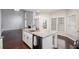 Bright kitchen with stainless appliances, an island, and views to the fireplace in the living room at 1533 Fallen Leaf Sw Dr, Marietta, GA 30064