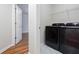Convenient laundry room with modern black washer and dryer units at 1533 Fallen Leaf Sw Dr, Marietta, GA 30064