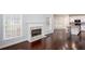 Bright living room features a fireplace, hardwood floors, and large windows offering natural light at 1533 Fallen Leaf Sw Dr, Marietta, GA 30064