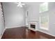 Cozy living room with a fireplace, high ceilings, and ample natural light from multiple windows at 1533 Fallen Leaf Sw Dr, Marietta, GA 30064