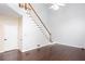Bright staircase features hardwood steps and white railings, complemented by hardwood floors and natural light at 1533 Fallen Leaf Sw Dr, Marietta, GA 30064