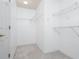 Empty walk-in closet features wall-mounted wire racks for functional storage in a compact space at 1533 Fallen Leaf Sw Dr, Marietta, GA 30064