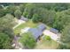 Aerial view of an estate with a large house, pool, outbuildings, and mature trees at 204 Mt Moriah Rd, Auburn, GA 30011
