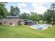 Large backyard with a swimming pool, screened in porch, and lush greenery at 204 Mt Moriah Rd, Auburn, GA 30011