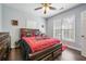 This bedroom has hardwood floors, fan, and a large window to let in light at 204 Mt Moriah Rd, Auburn, GA 30011