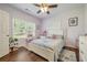 Bedroom with a window, hardwood floors, and pink decorations at 204 Mt Moriah Rd, Auburn, GA 30011