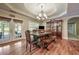 Elegant dining room with hardwood floors, chandelier, and access to the outdoor deck at 204 Mt Moriah Rd, Auburn, GA 30011