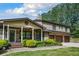 Charming brick home with a welcoming front porch, lush landscaping, and an attached three-car garage at 204 Mt Moriah Rd, Auburn, GA 30011