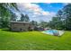 Expansive backyard features a sparkling pool, screened in porch, and a lush lawn at 204 Mt Moriah Rd, Auburn, GA 30011