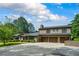 Beautiful brick home with an attached three-car garage, a spacious driveway, and well-maintained greenery at 204 Mt Moriah Rd, Auburn, GA 30011