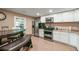 Spacious kitchen features stainless steel appliances, white cabinets, and tile floors at 204 Mt Moriah Rd, Auburn, GA 30011