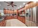 Modern kitchen featuring stainless steel appliances, wooden cabinets, tile flooring, and a functional layout at 204 Mt Moriah Rd, Auburn, GA 30011