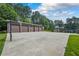 Large detached garage with basketball hoops and ample parking on a concrete pad at 204 Mt Moriah Rd, Auburn, GA 30011
