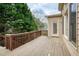 Wood deck with railings and a view of the tree-lined backyard at 300 Maple Grove Ct, Canton, GA 30114