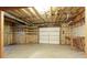 Unfinished basement with insulation, electrical, and a garage door at 300 Maple Grove Ct, Canton, GA 30114