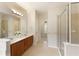 Bathroom with double vanity, large mirror, tiled floors, and glass-enclosed shower at 300 Maple Grove Ct, Canton, GA 30114