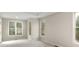 Bedroom featuring neutral carpeting, tray ceilings, and multiple windows for natural light at 300 Maple Grove Ct, Canton, GA 30114