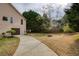 Exterior side view of home with well-maintained landscaping and a long driveway at 300 Maple Grove Ct, Canton, GA 30114