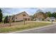 Beige two-story home with two-car garage, tidy front lawn, and mature trees, located in a suburban neighborhood at 300 Maple Grove Ct, Canton, GA 30114