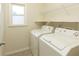 Functional laundry room with washer, dryer, shelving and window at 300 Maple Grove Ct, Canton, GA 30114
